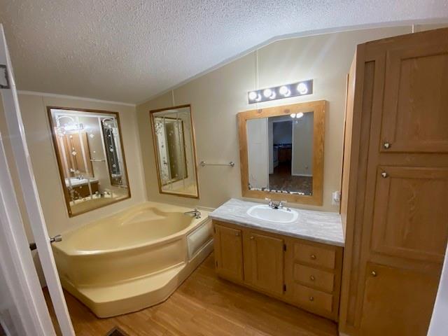 1620 East Reno Road, Unit 21 Azle, TX 76020 - Photo 7 of 10 a bathroom with 2 sink tub and a mirror