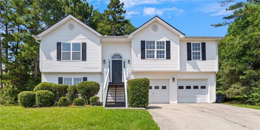 1718 Fort Connors Way Dacula, GA 30019 - Photo 1 of 1 a front view of a house with a yard and garage