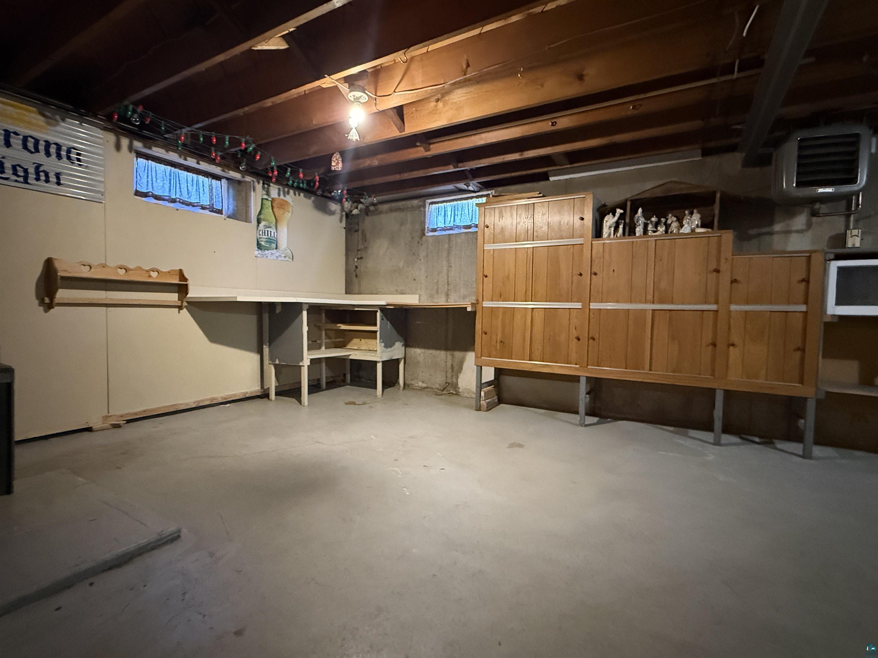 607 3rd Street Northeast Chisholm, MN 55719 - Photo 25 of 32 Unfinished basement with exposed wood ceiling joists and concrete flooring