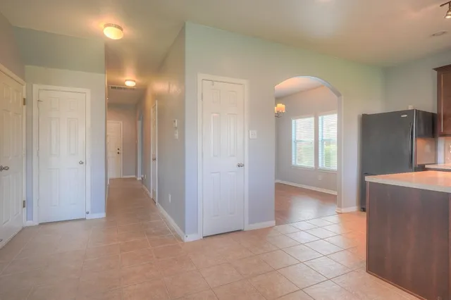 a view of a kitchen with a refrigerator and a sink