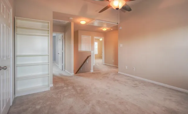 a view of an empty room with a fan