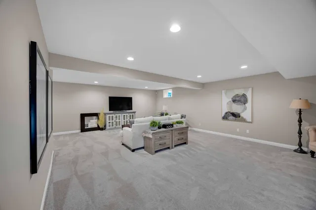 a bedroom with a large bed chandelier and a window
