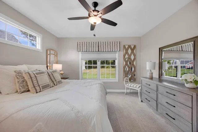 a front view of a house with a yard and trees