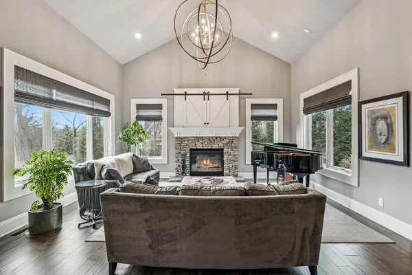 a living room with furniture a window and a fireplace