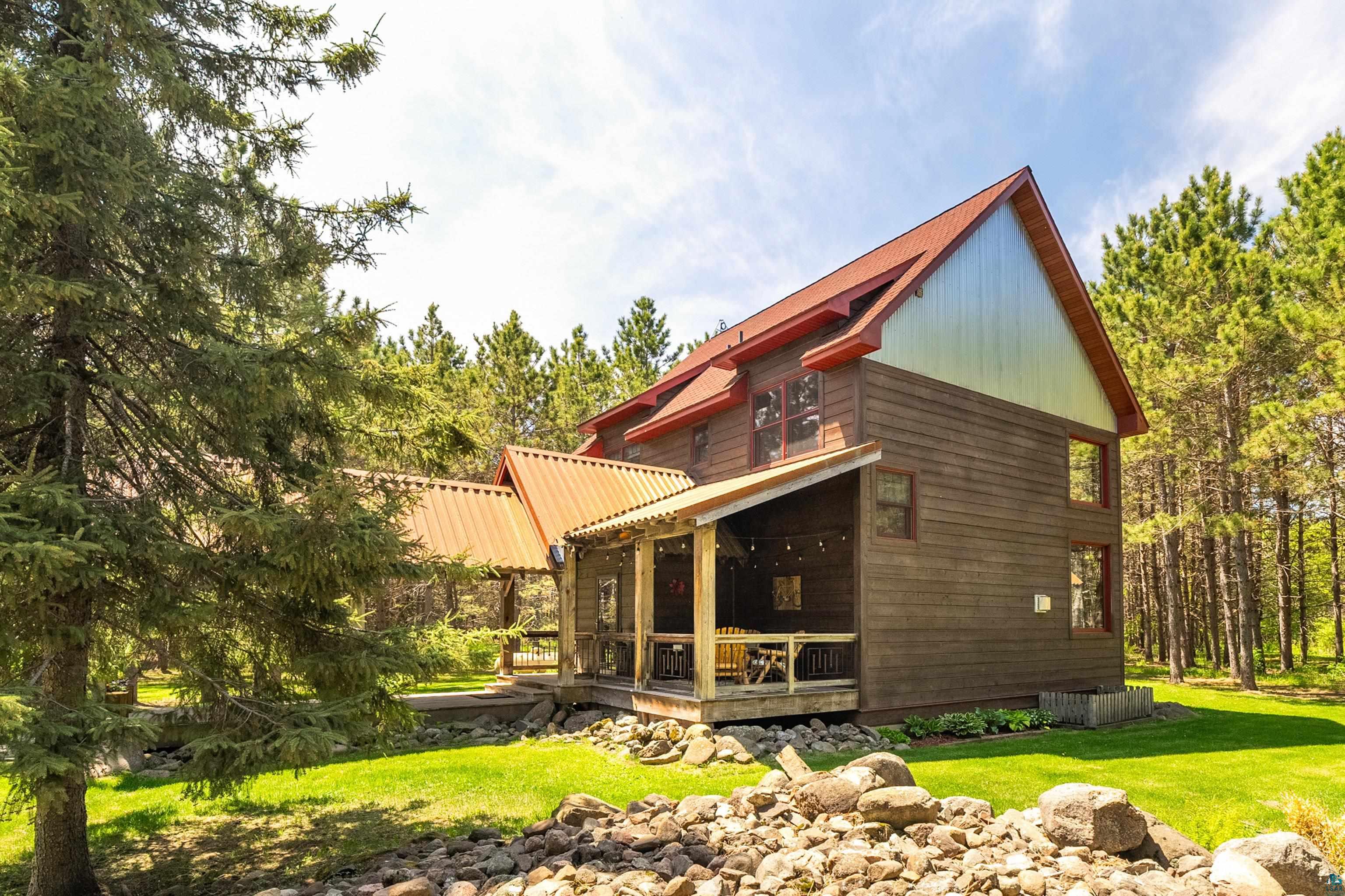 75 East Stark Road Esko, MN 55733 - Photo 59 of 87 Rustic-style dwelling featuring a covered porch, brown wood-finish siding, and a red metal roof
