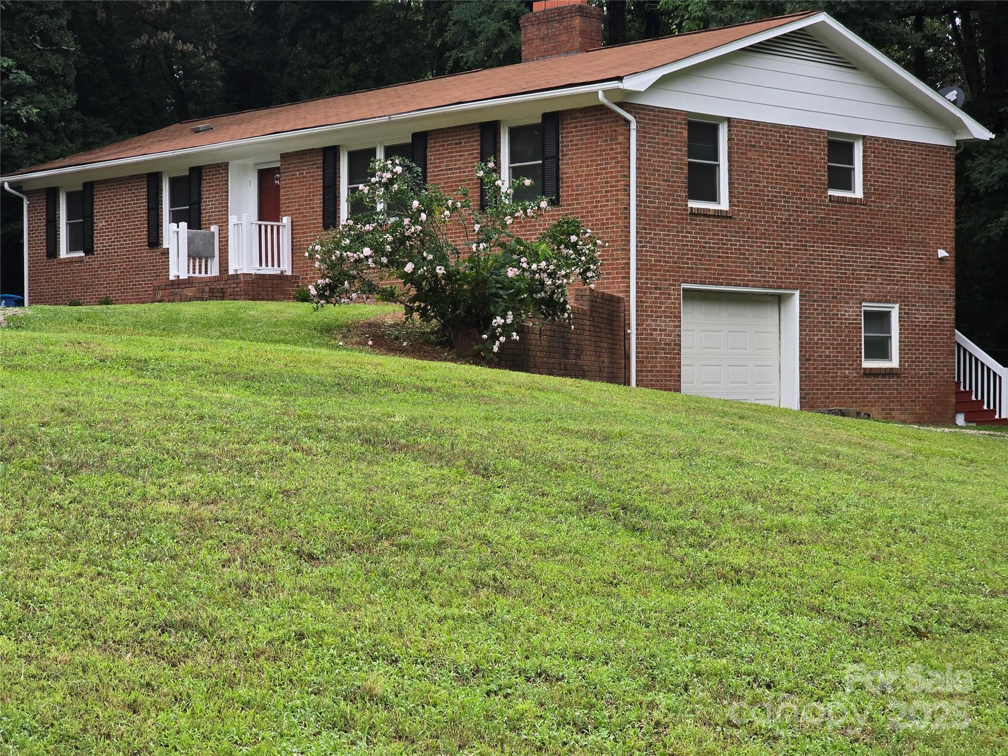 a front view of house with yard and green space