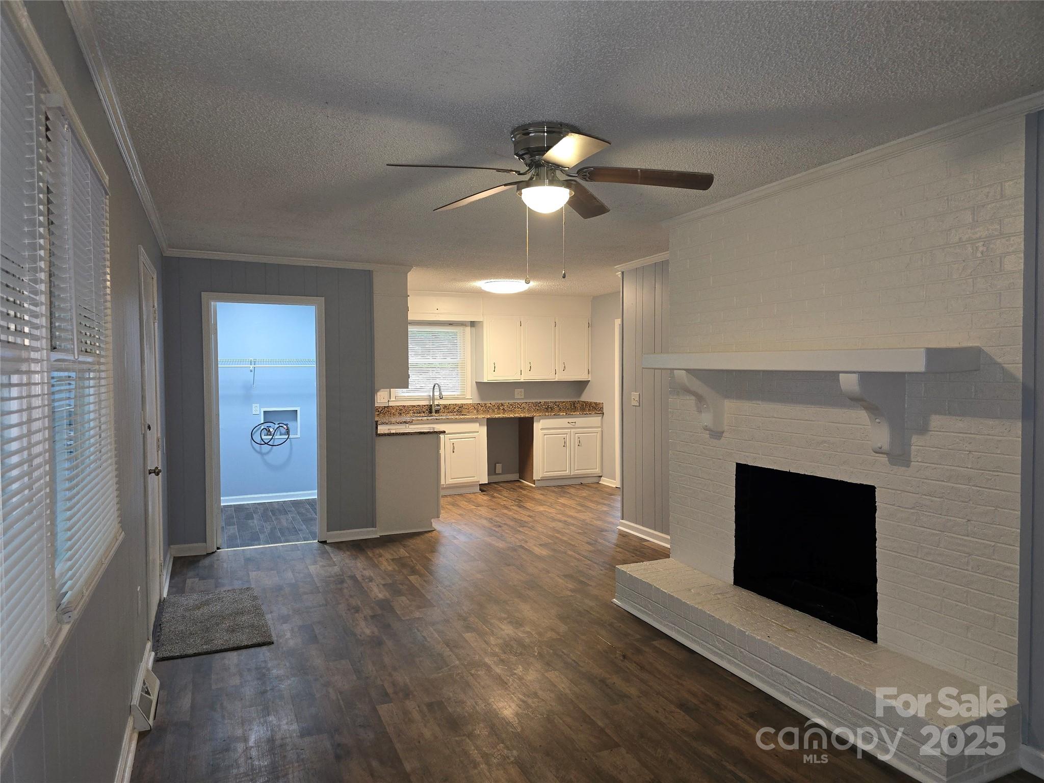 1660 Songwood Road Concord, NC 28025 - Photo 11 of 32 a view of an empty room with kitchen and fireplace
