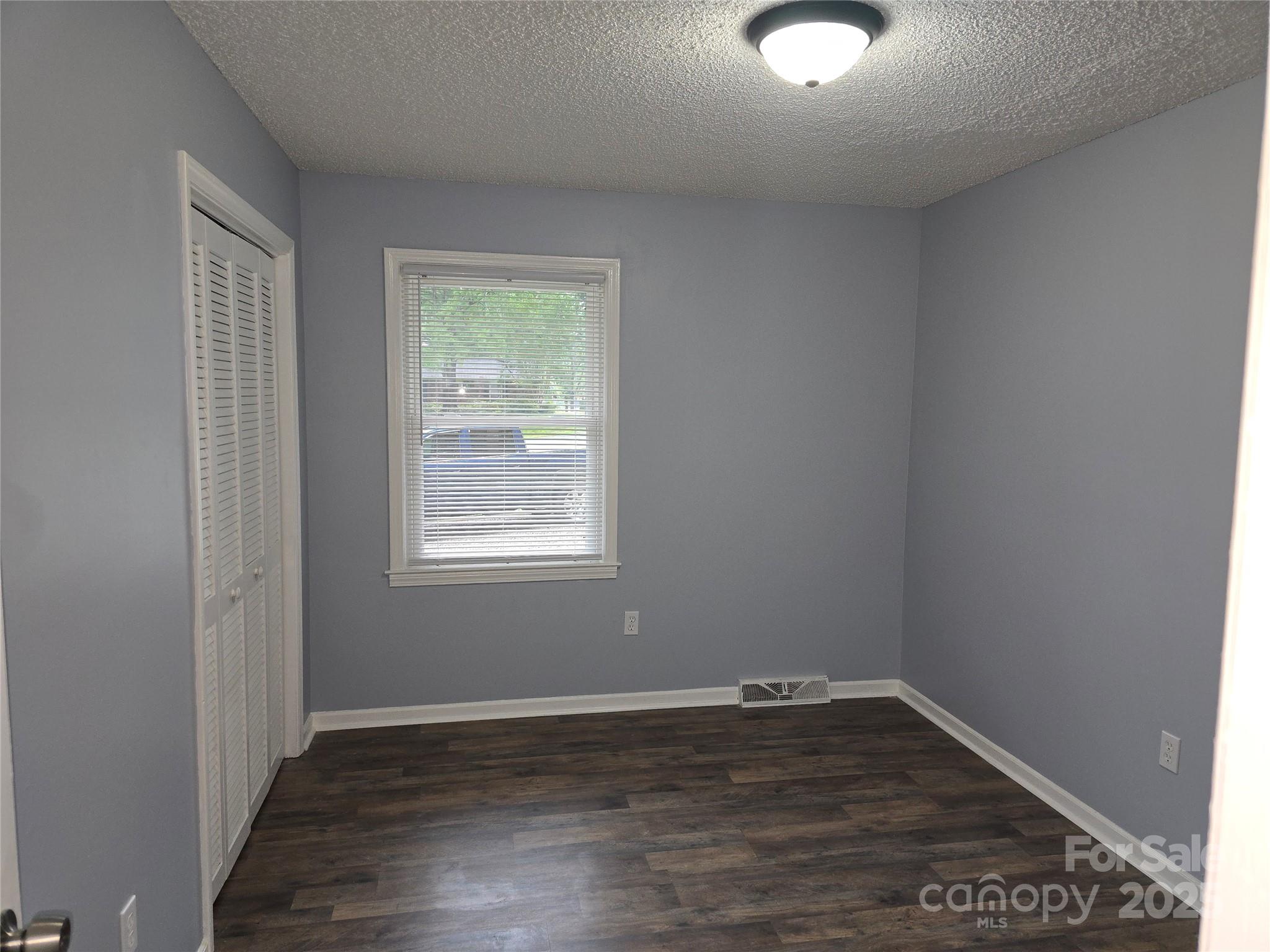 1660 Songwood Road Concord, NC 28025 - Photo 15 of 32 an empty room with wooden floor and windows