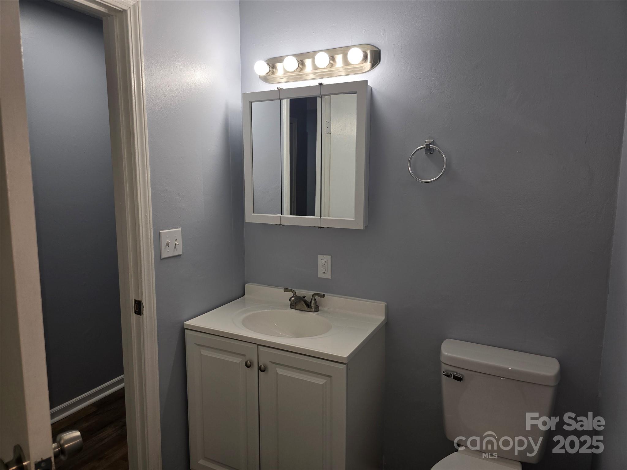 1660 Songwood Road Concord, NC 28025 - Photo 17 of 32 a bathroom with a toilet sink and mirror