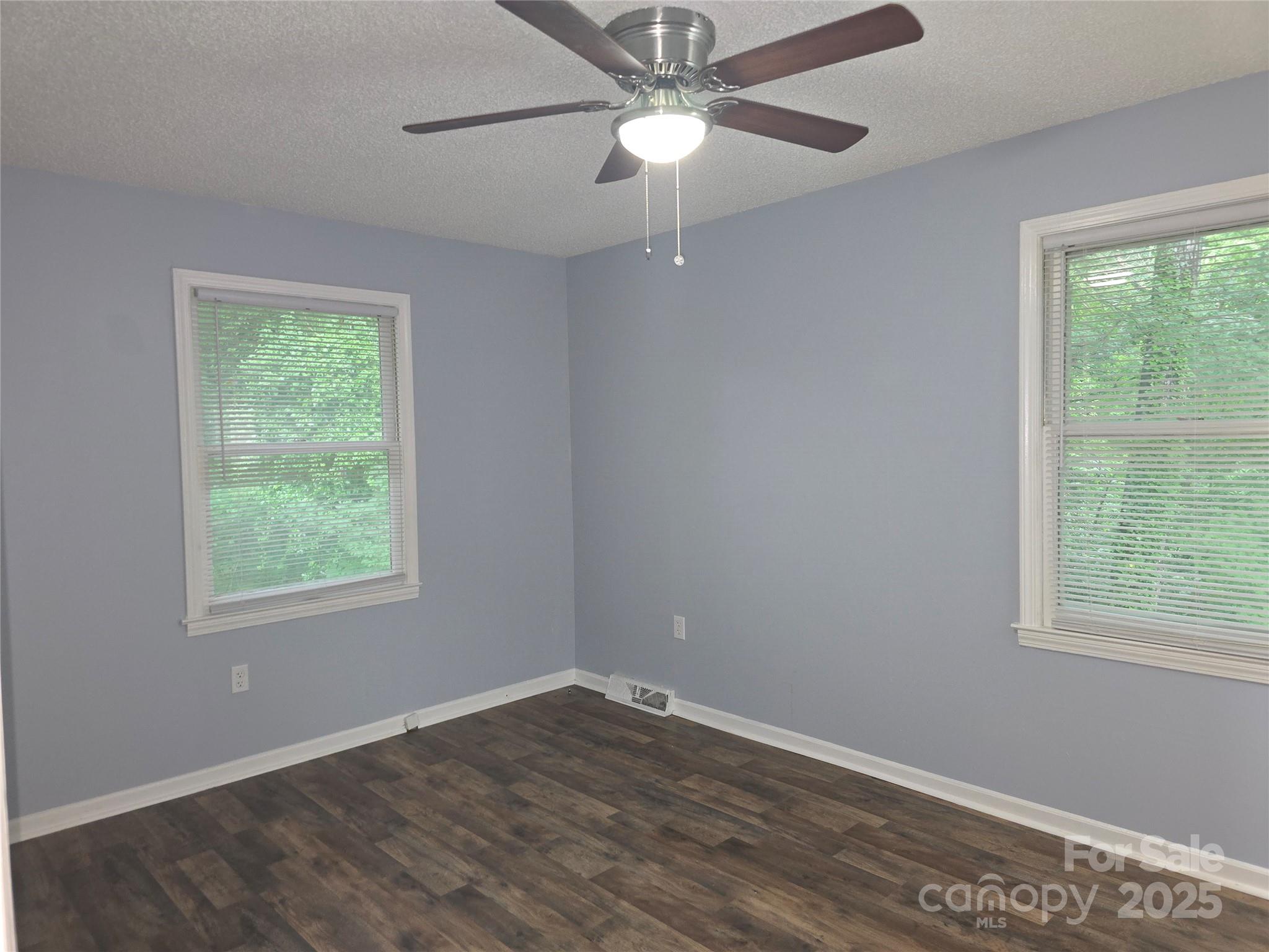 1660 Songwood Road Concord, NC 28025 - Photo 18 of 32 a view of an empty room with wooden floor and a window