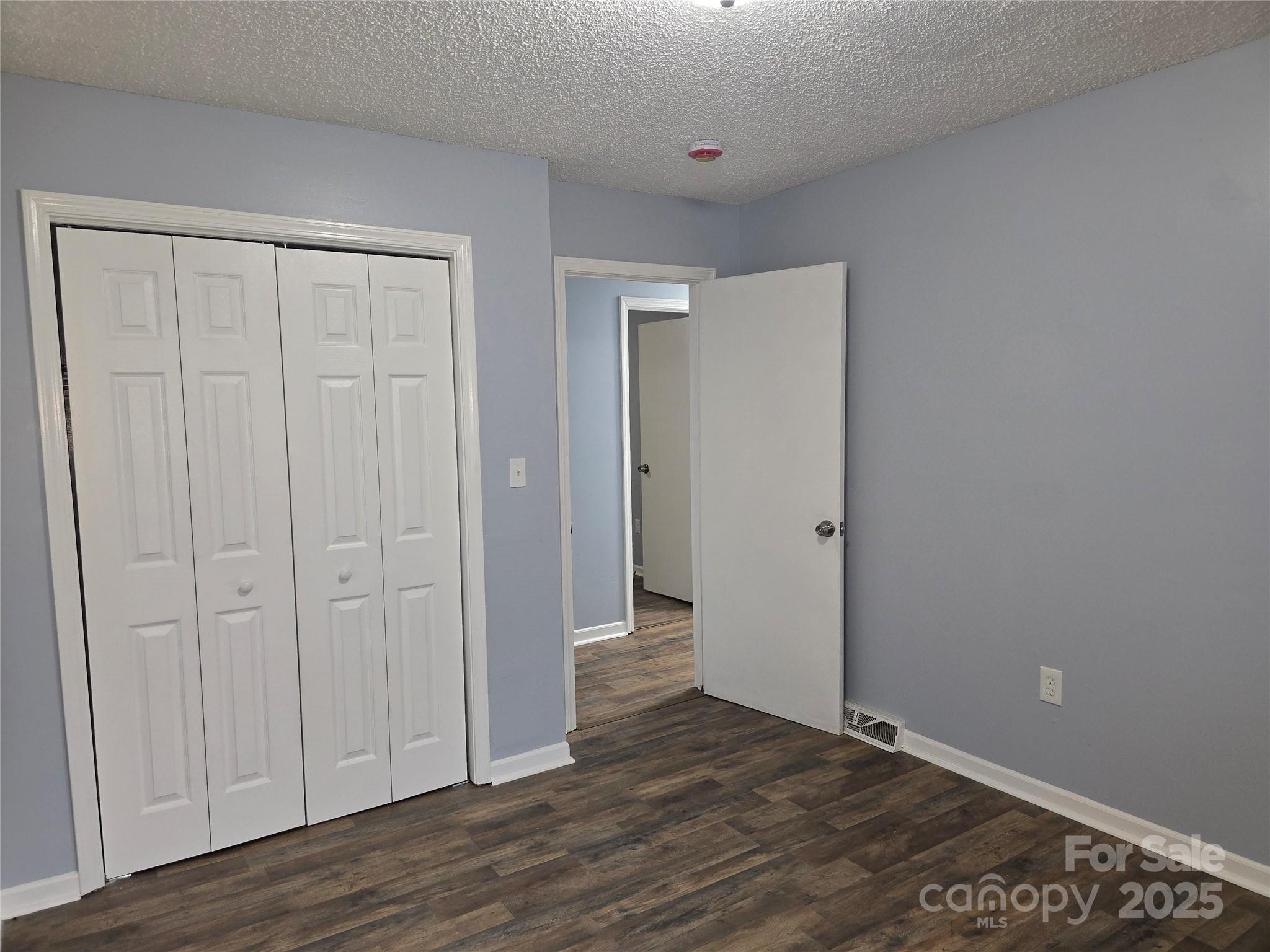 1660 Songwood Road Concord, NC 28025 - Photo 22 of 32 a view of an empty room with wooden floor