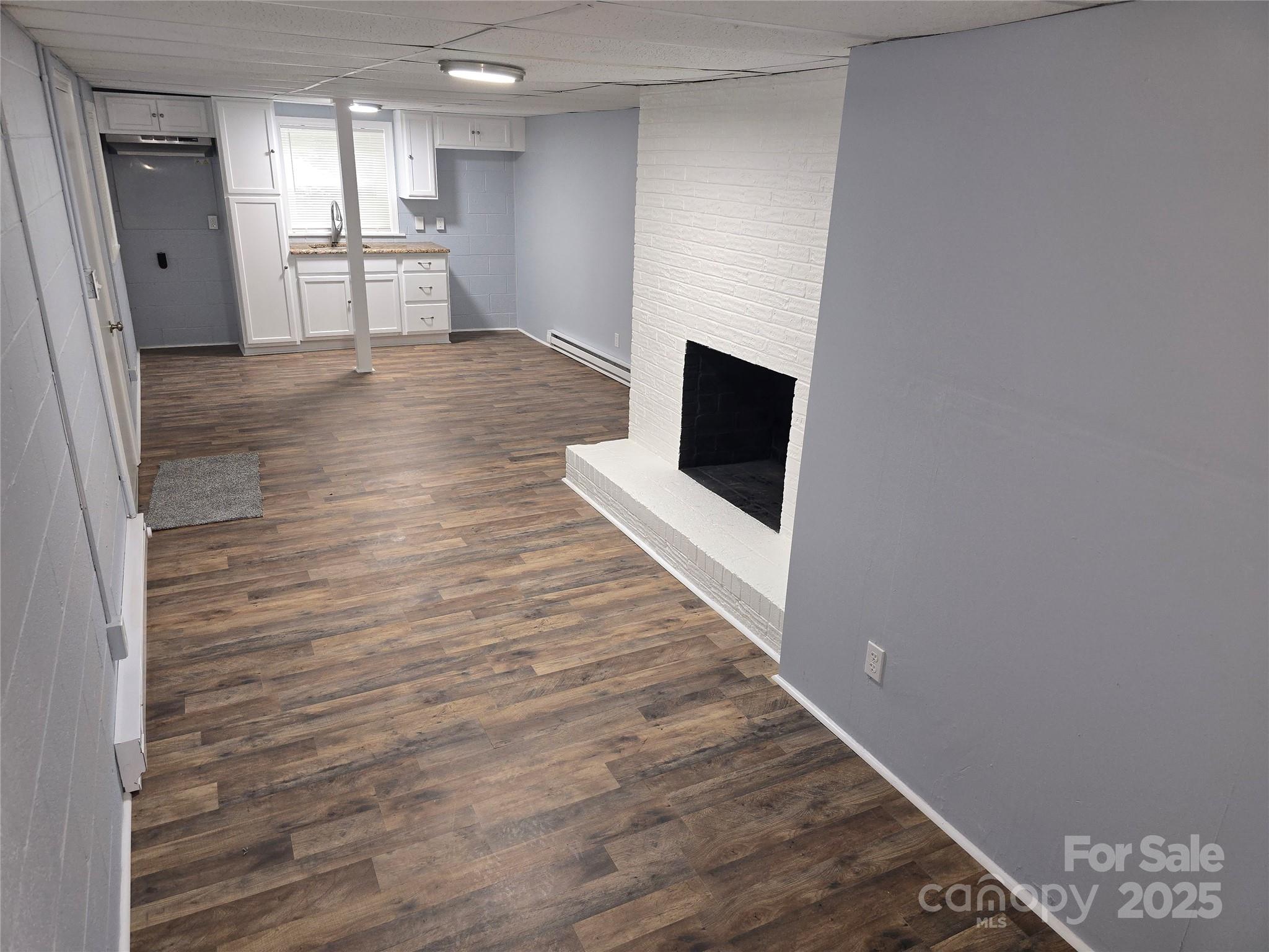 1660 Songwood Road Concord, NC 28025 - Photo 24 of 32 a view of a kitchen with wooden floor and a refrigerator