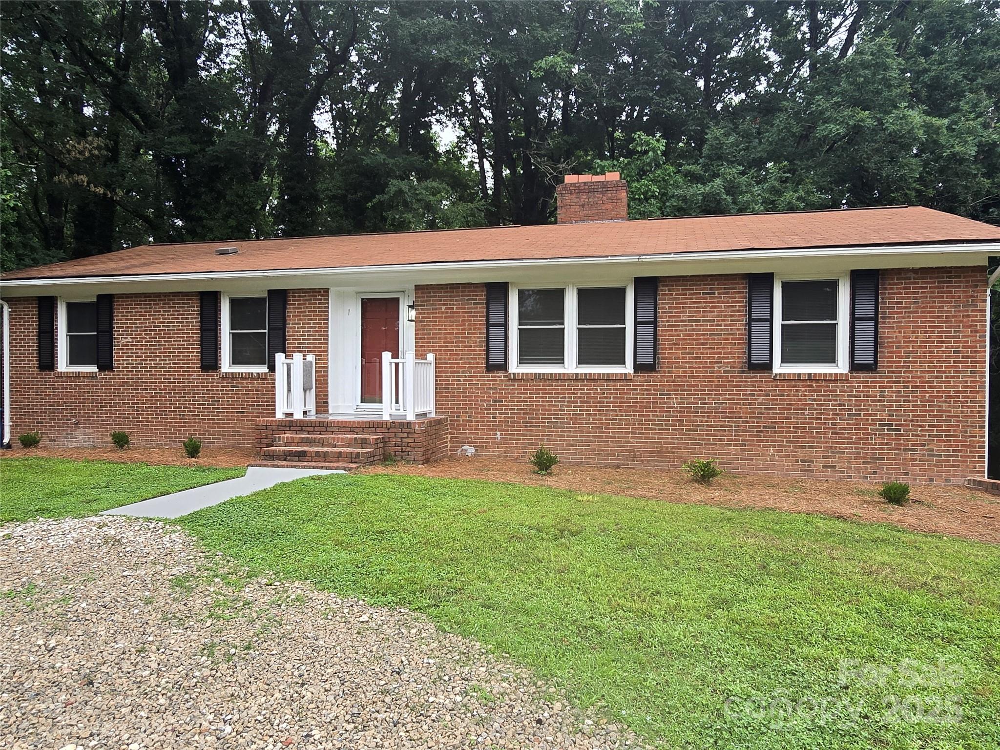 1660 Songwood Road Concord, NC 28025 - Photo 3 of 32 a front view of a house with a yard