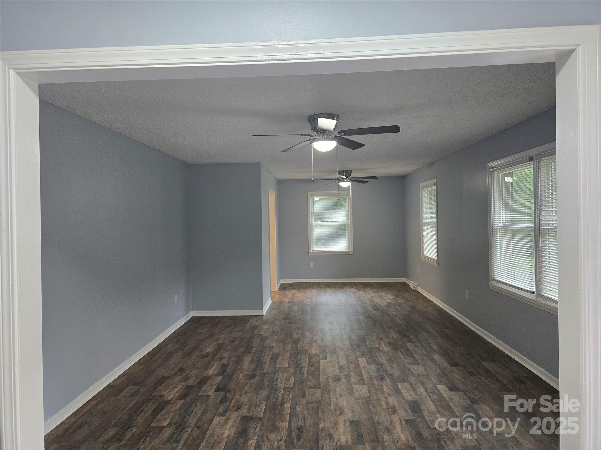 1660 Songwood Road Concord, NC 28025 - Photo 6 of 32 a view of an empty room with window and wooden floor