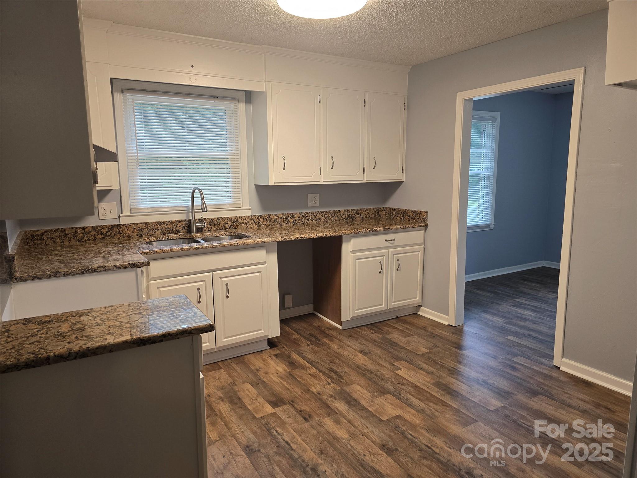 1660 Songwood Road Concord, NC 28025 - Photo 9 of 32 a kitchen with a sink cabinets and wooden floor