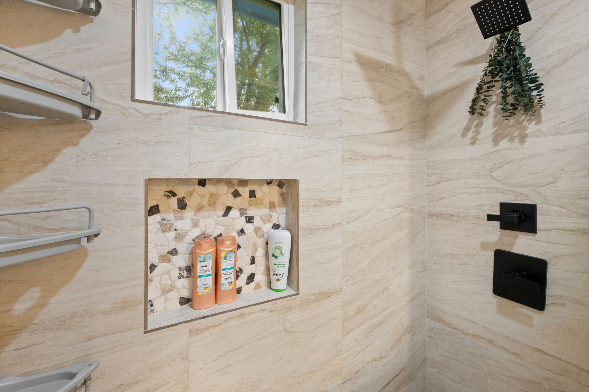 907 East 53rd Street Austin, TX 78751 - Photo 30 of 36 A well-appointed shower offers an integrated niche and a window for natural light.