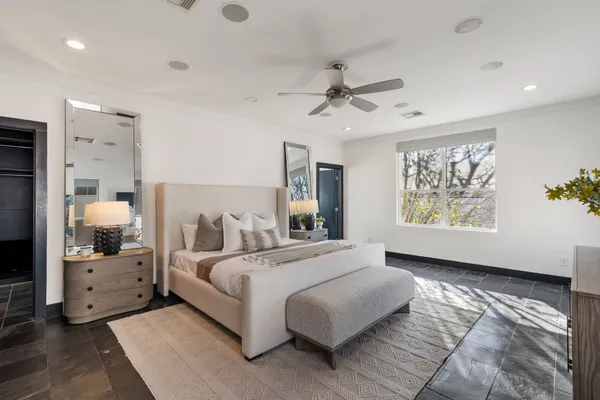 a bedroom with a large bed and a window