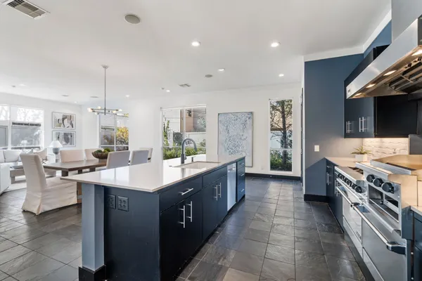 a kitchen with a sink stove and cabinets