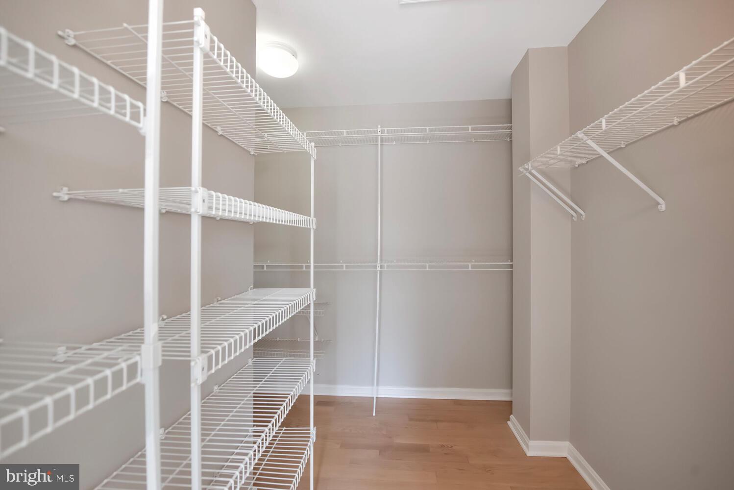 20881 Trinity Square Sterling, VA 20165 - Photo 15 of 35 a view of an empty room with wooden floor and windows