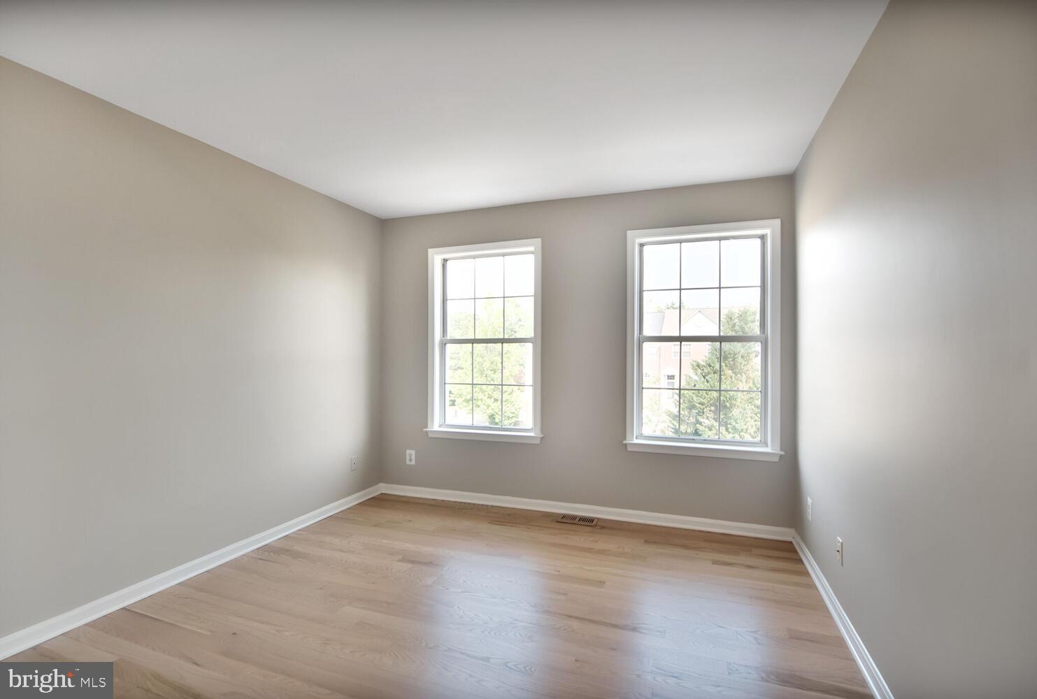 20881 Trinity Square Sterling, VA 20165 - Photo 17 of 35 an empty room with wooden floor and windows