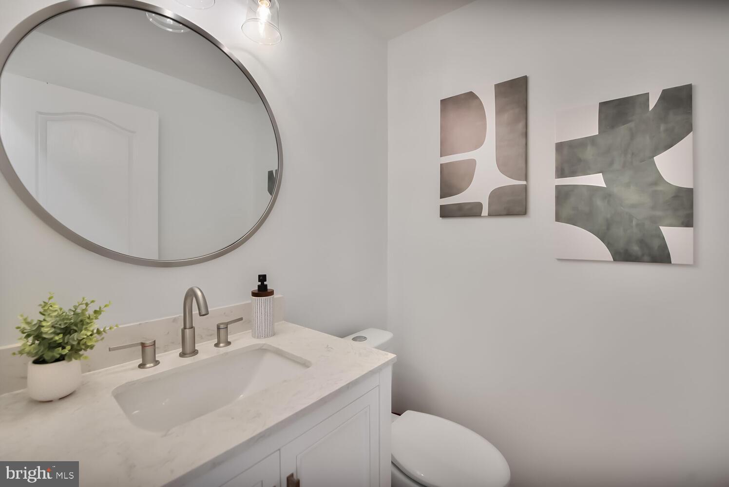 20881 Trinity Square Sterling, VA 20165 - Photo 22 of 35 a bathroom with a sink mirror and toilet