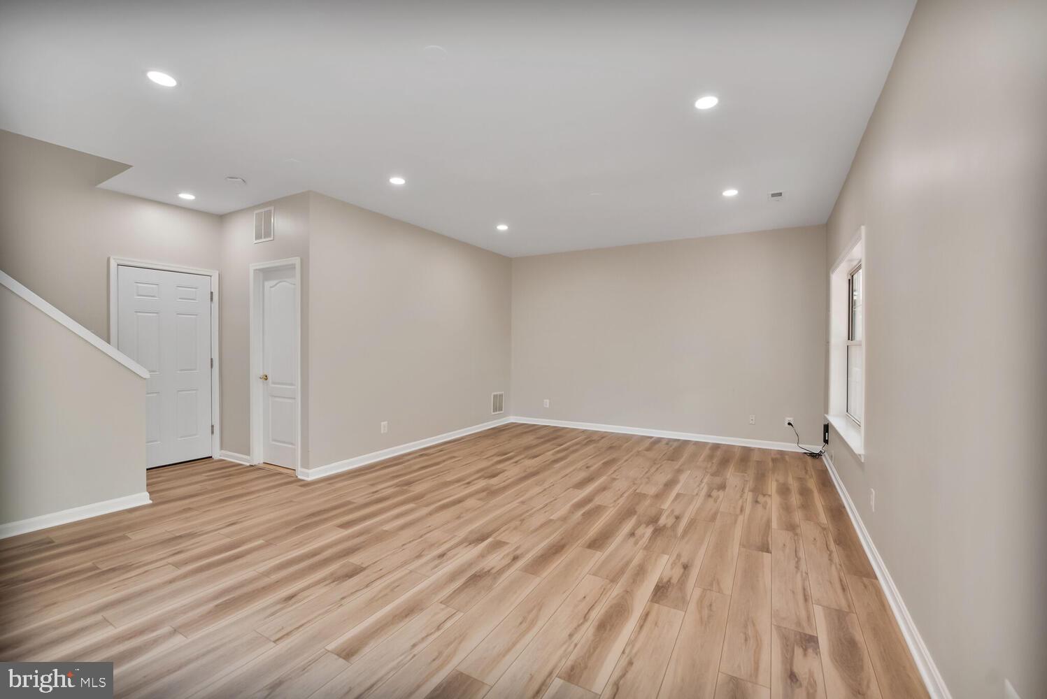20881 Trinity Square Sterling, VA 20165 - Photo 23 of 35 a view of an empty room with wooden floor and entryway