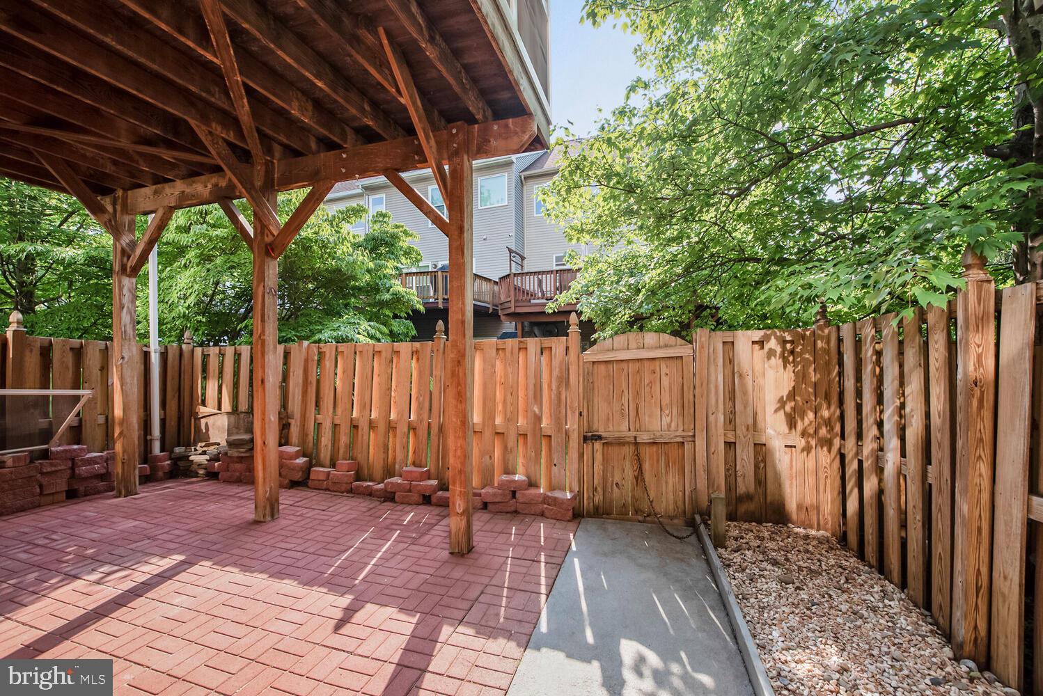 20881 Trinity Square Sterling, VA 20165 - Photo 25 of 35 a view of a backyard with wooden fence and a large tree