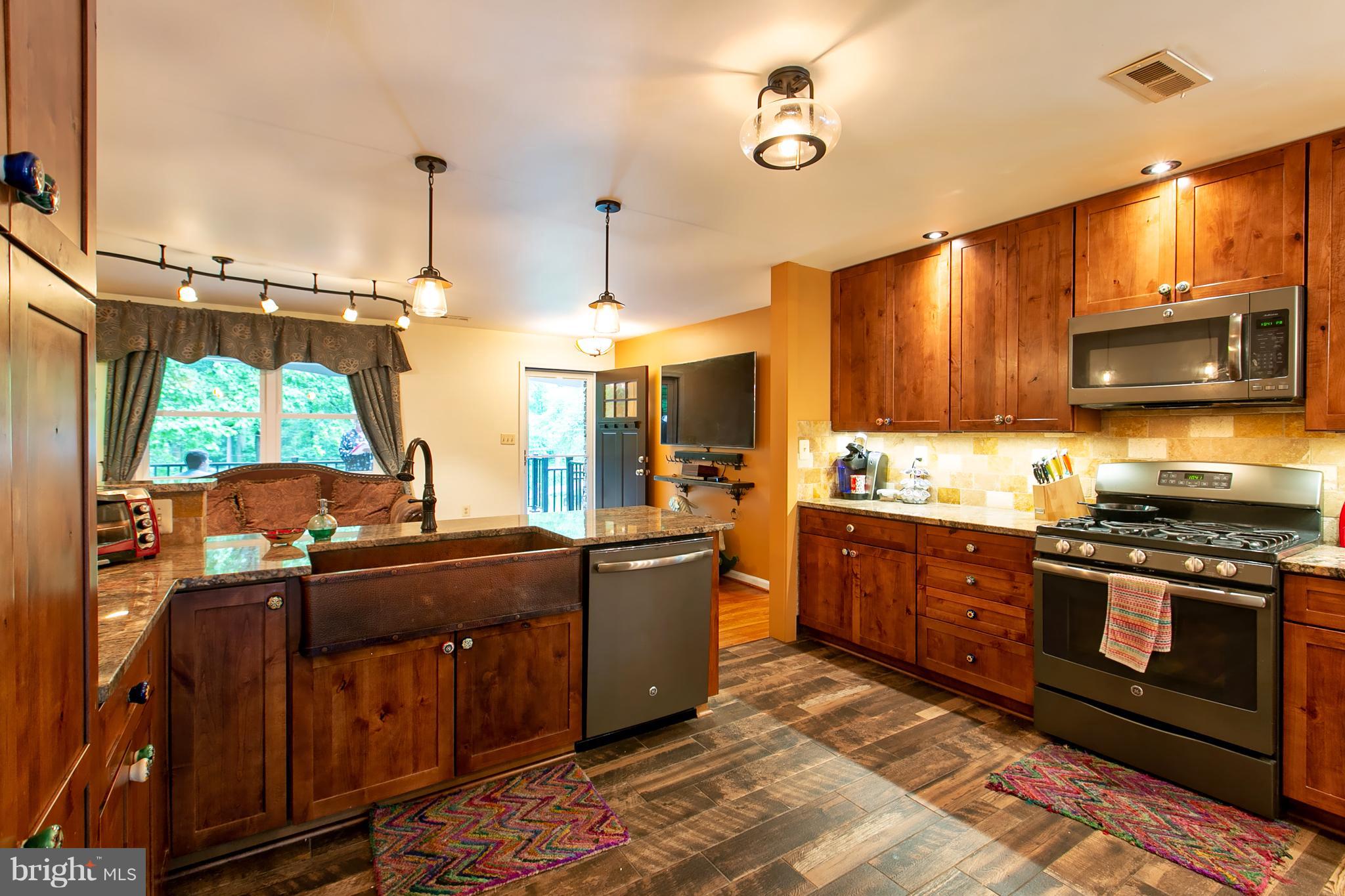 13015 Bottom Road Hydes, MD 21082 - Photo 5 of 30 a kitchen with stainless steel appliances granite countertop a stove a sink and a microwave