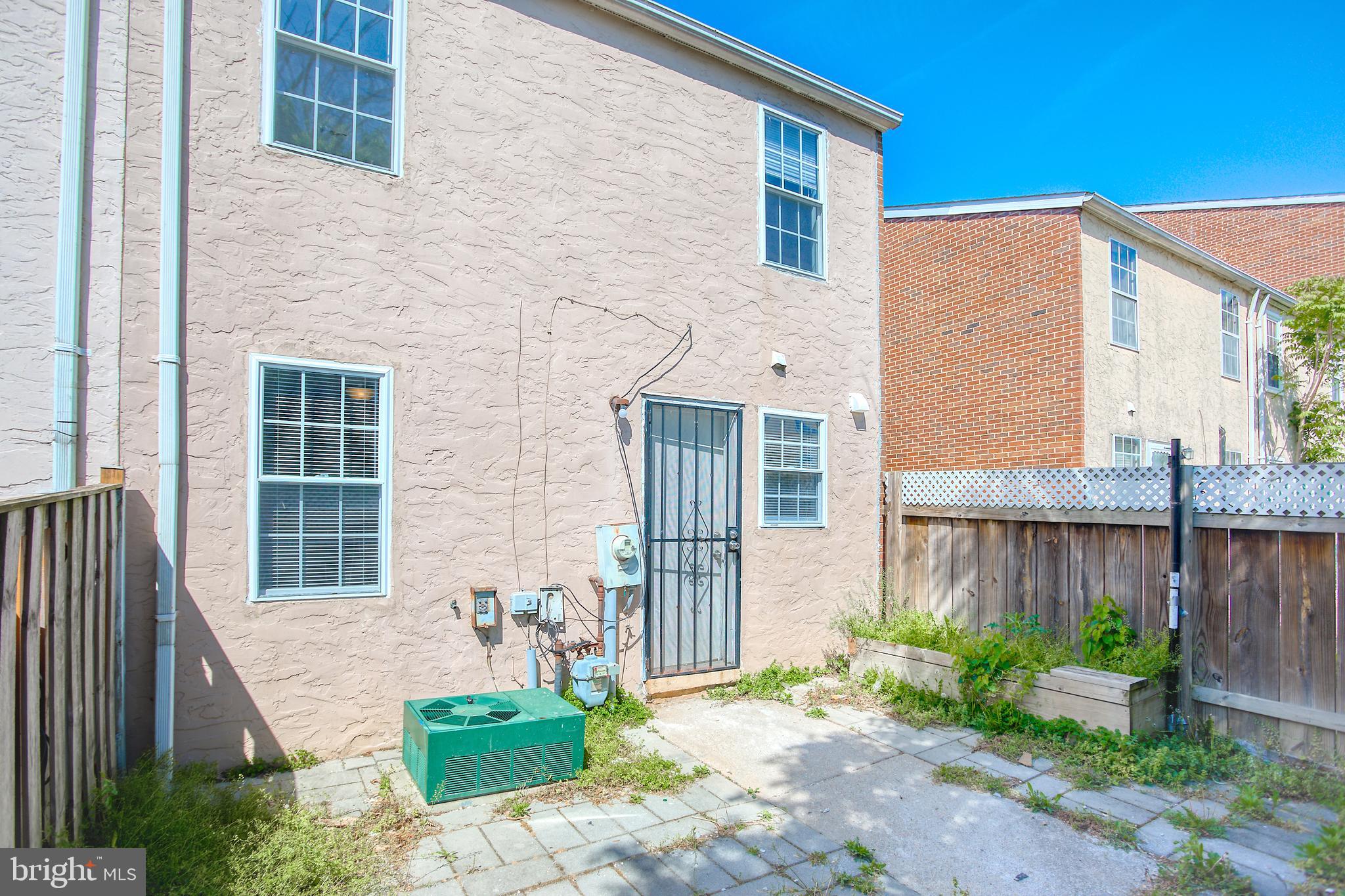 819 Aisquith Street Baltimore, MD 21202 - Photo 12 of 26 a front view of a house with a garden