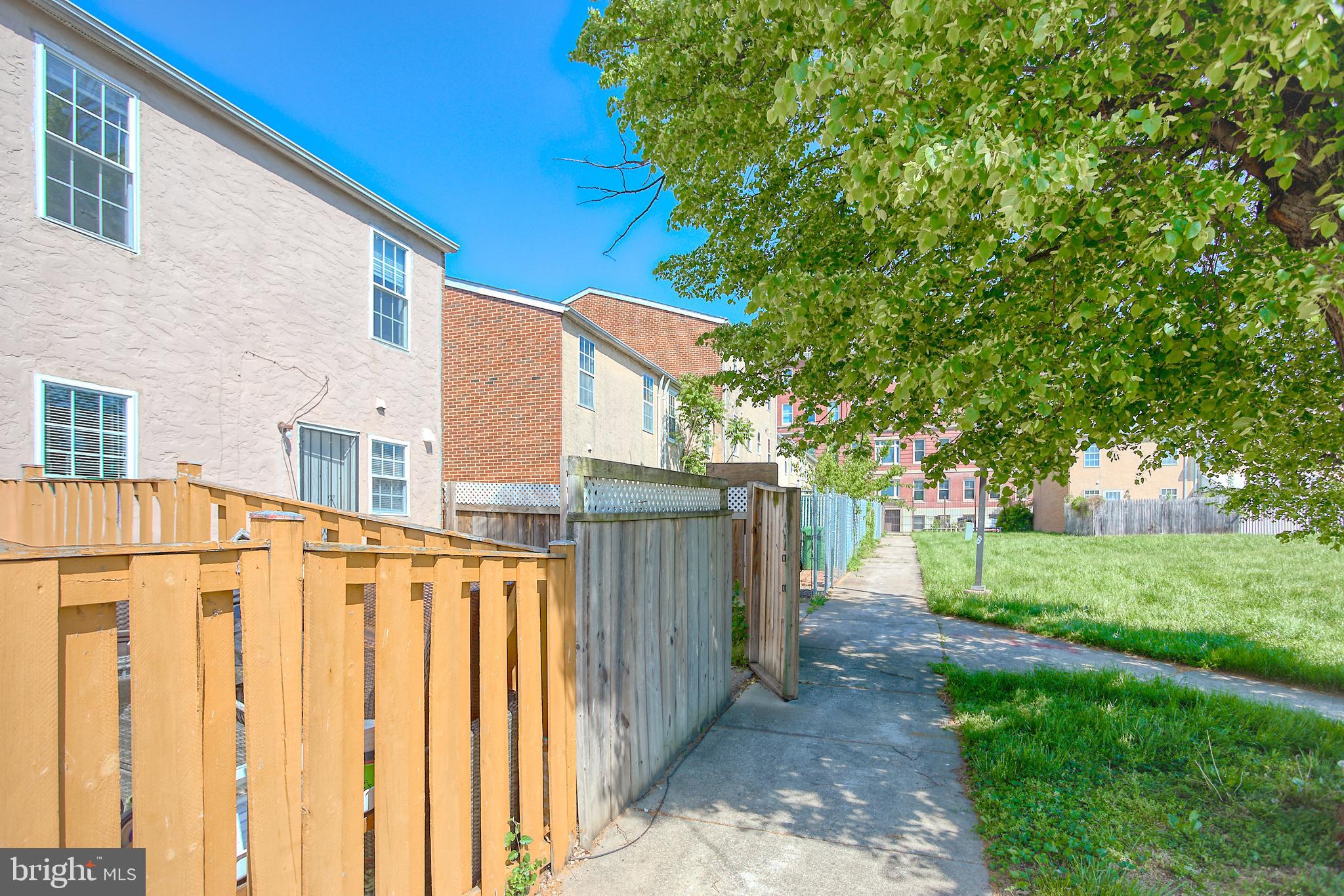 819 Aisquith Street Baltimore, MD 21202 - Photo 14 of 26 a view of a house with backyard and trees