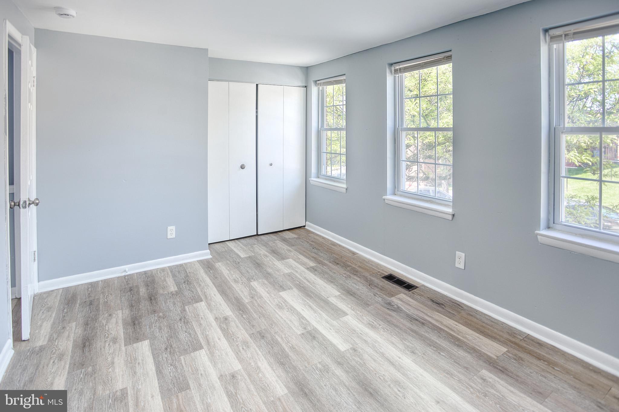 819 Aisquith Street Baltimore, MD 21202 - Photo 19 of 26 a view of an empty room with wooden floor and a window