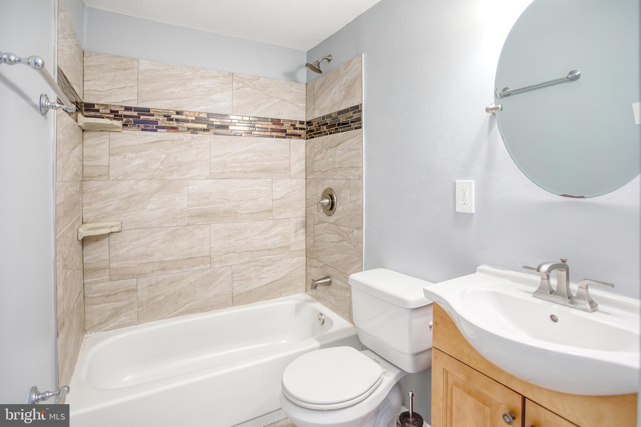 819 Aisquith Street Baltimore, MD 21202 - Photo 20 of 26 a bathroom with a sink toilet and shower
