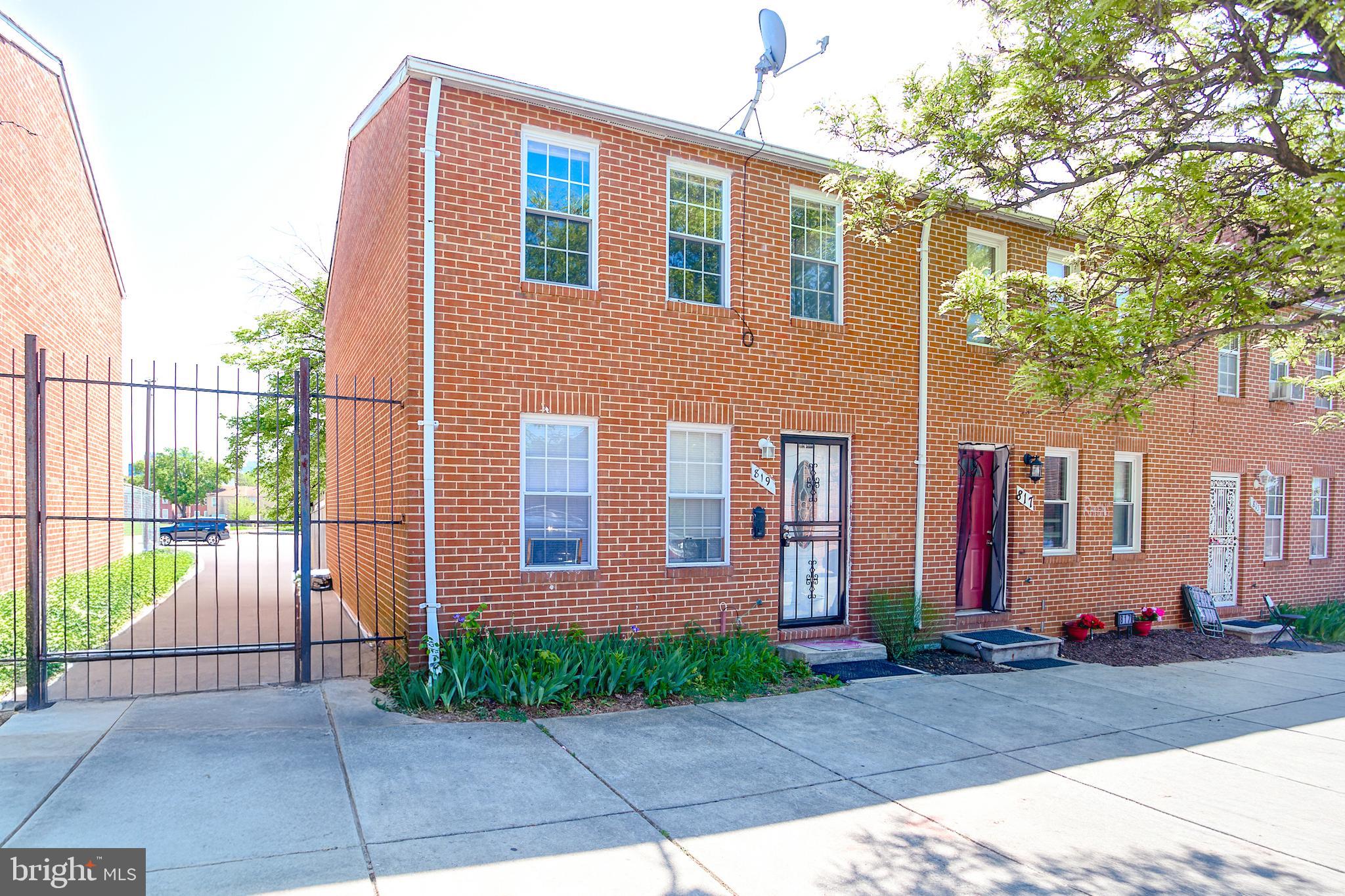 819 Aisquith Street Baltimore, MD 21202 - Photo 2 of 26 a front view of a house with a yard