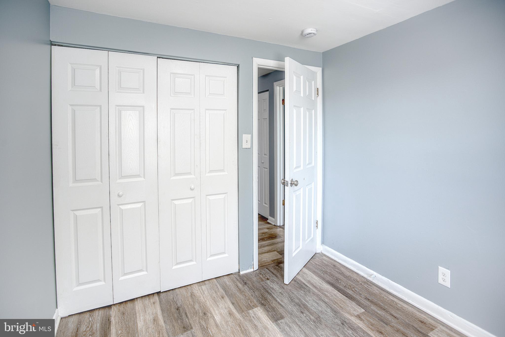 819 Aisquith Street Baltimore, MD 21202 - Photo 24 of 26 an empty room with wooden floor