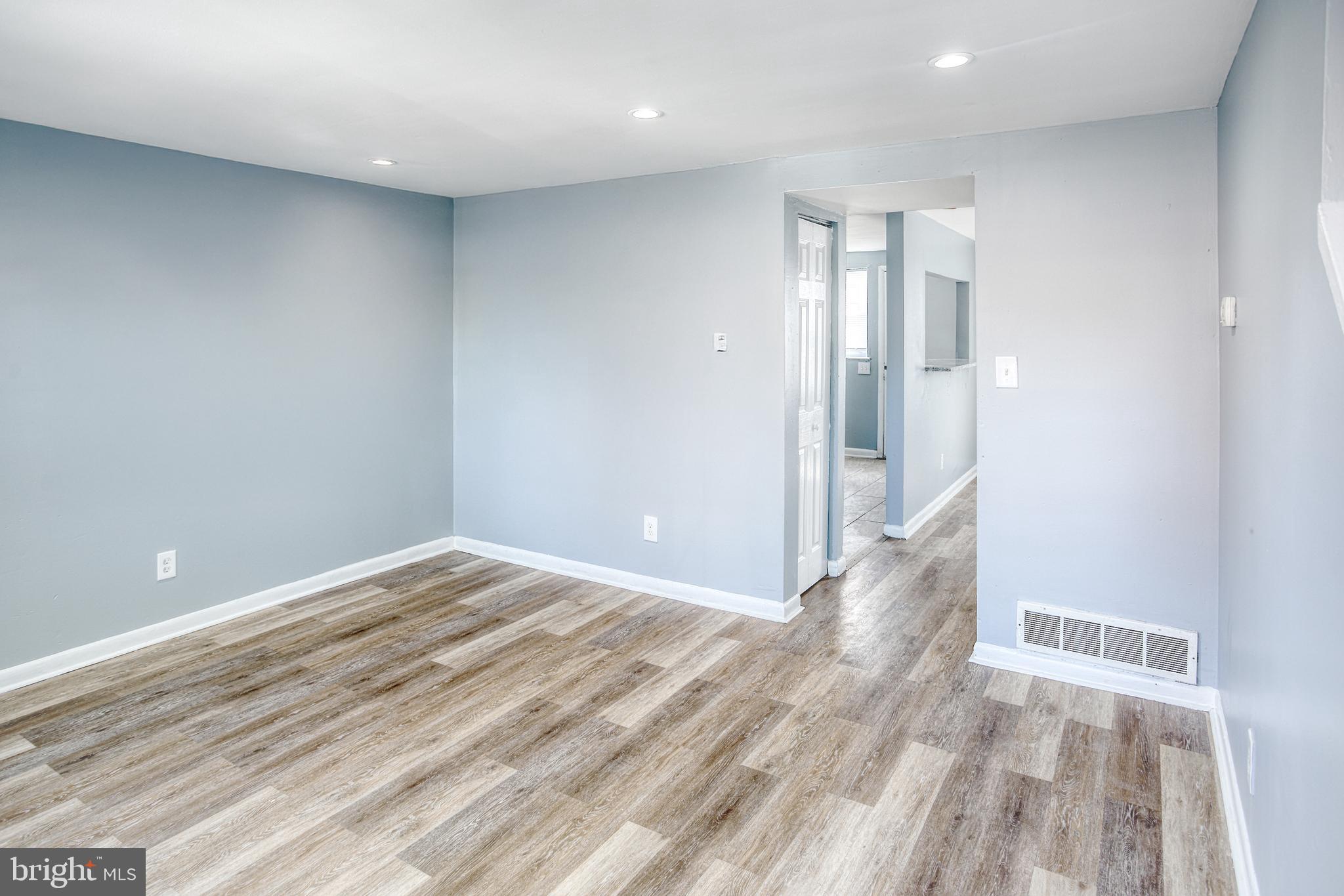 819 Aisquith Street Baltimore, MD 21202 - Photo 4 of 26 a view of hallway with wooden floor