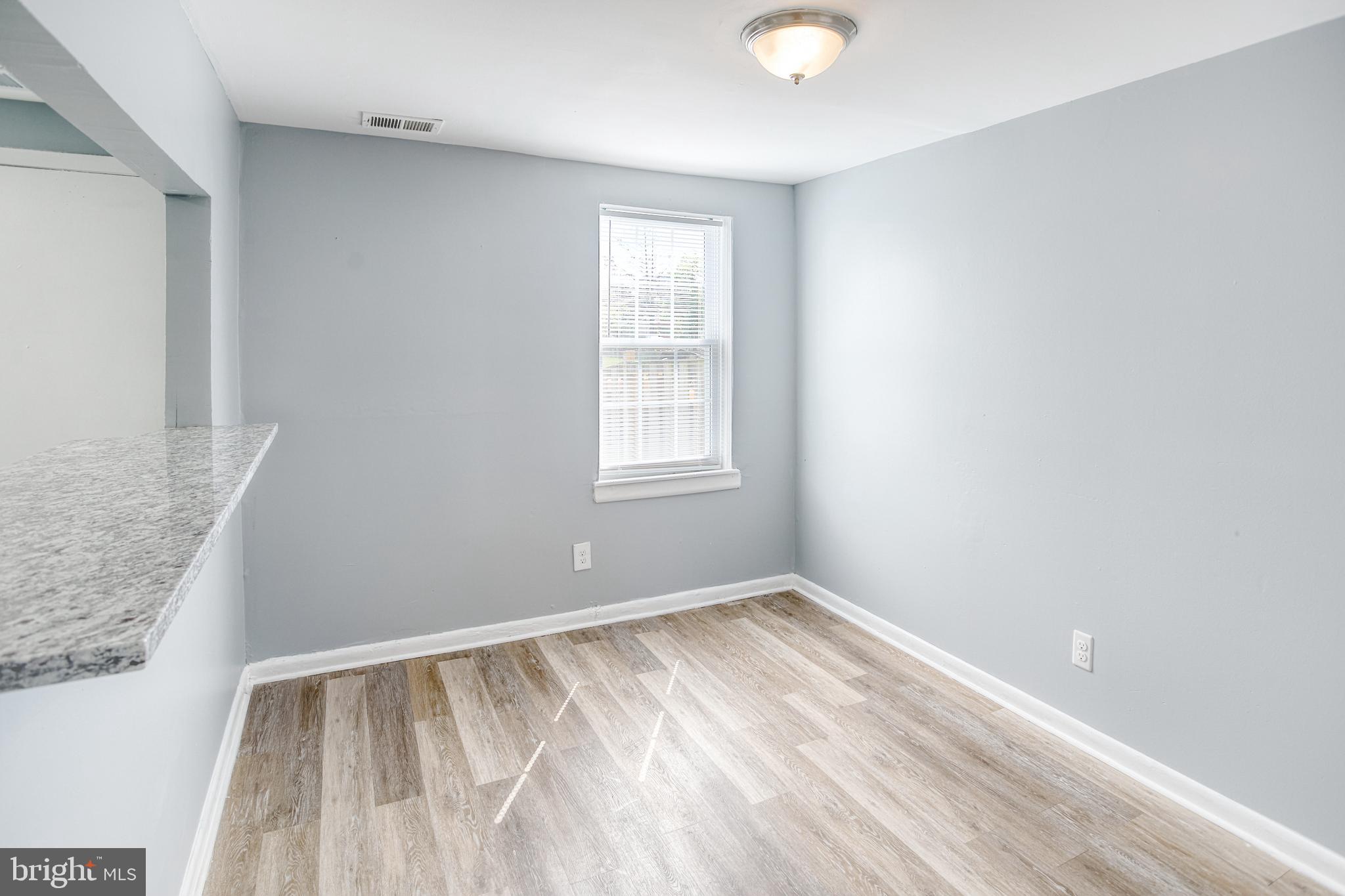 819 Aisquith Street Baltimore, MD 21202 - Photo 8 of 26 an empty room with windows