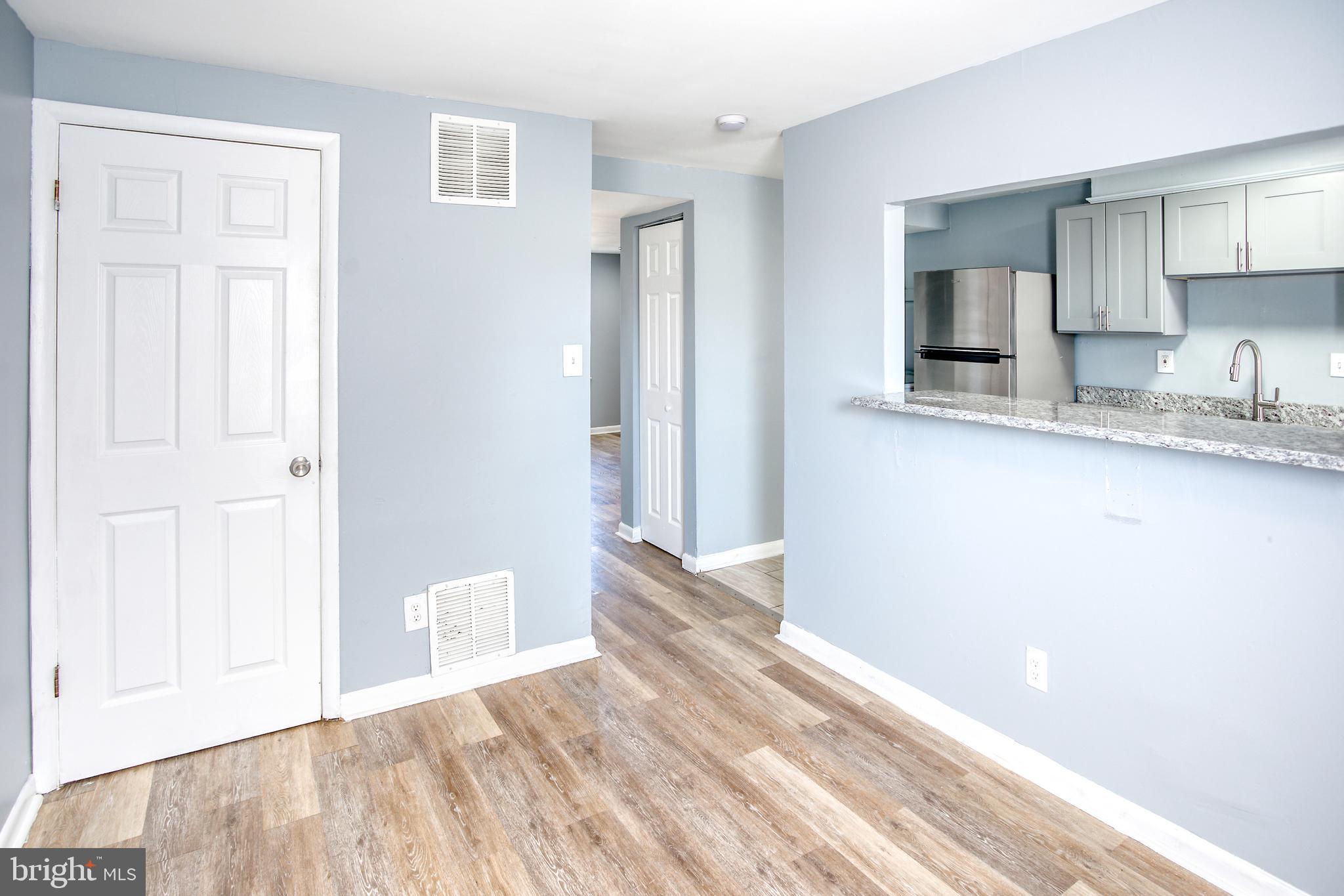 819 Aisquith Street Baltimore, MD 21202 - Photo 9 of 26 a view of a kitchen from the hallway