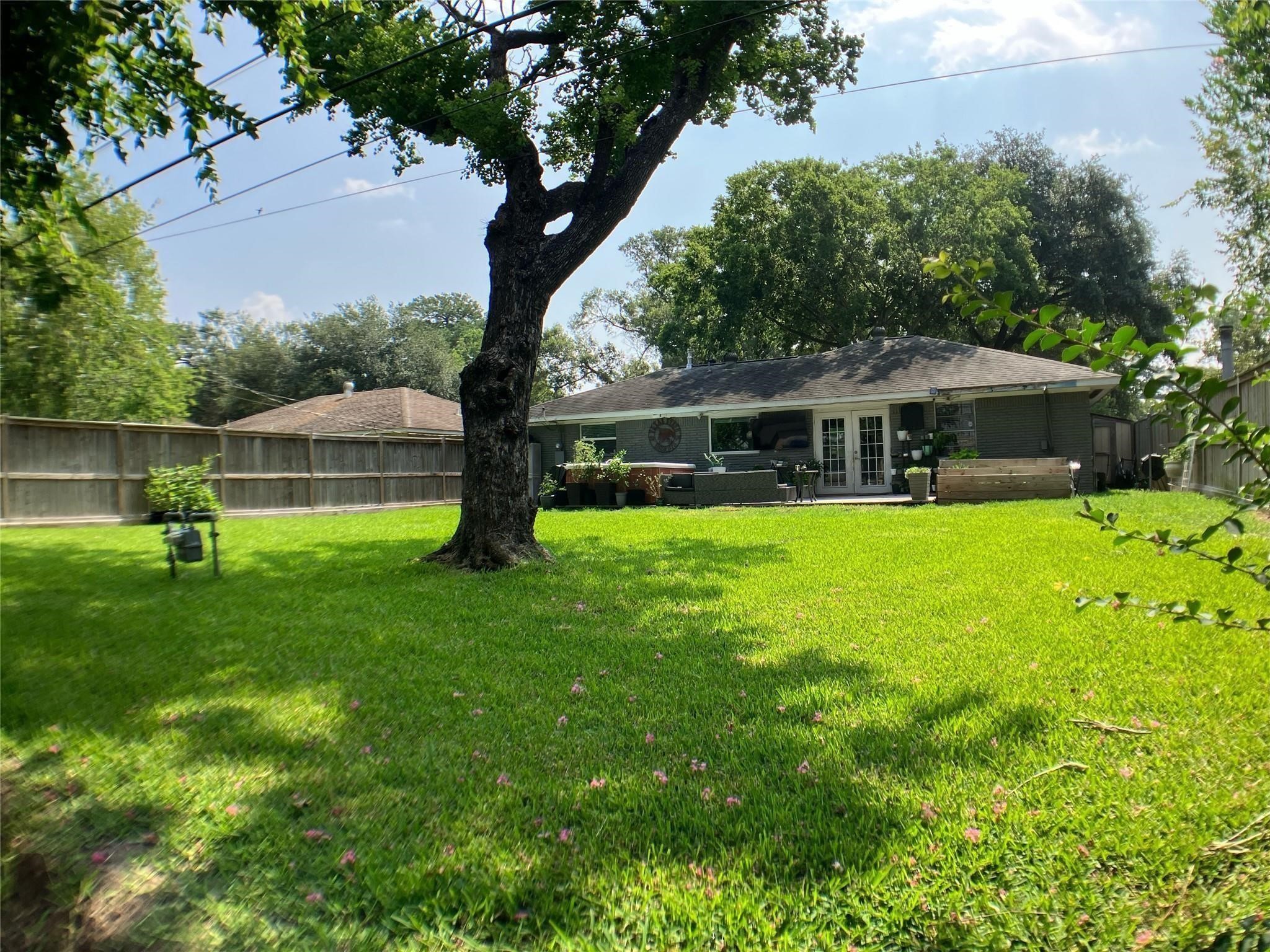 3027 Guese Road Houston, TX 77018 - Photo 18 of 22 Large fully fenced backyard features mature shade trees and plenty of green space to enjoy.