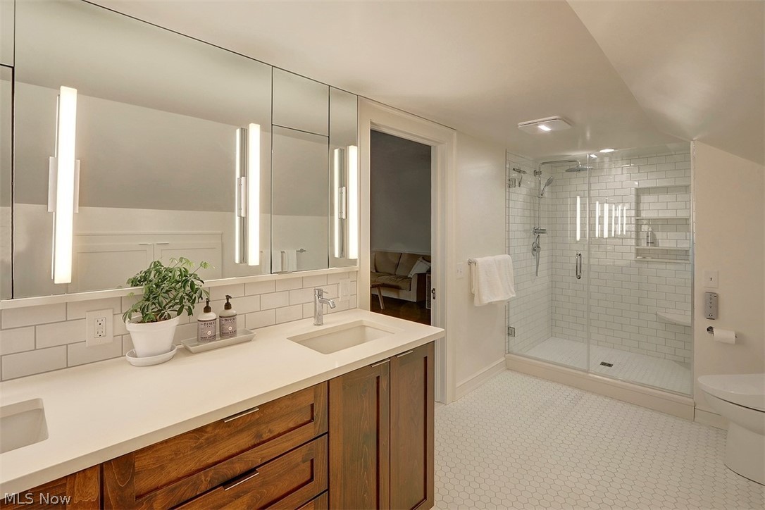 2115 Lamberton Road Cleveland, OH 44118 - Photo 18 of 29 The private owner's bath has been recently renovated and features double sinks, terrific storage, a walk-in shower with white subway tile. The perfect, private retreat.