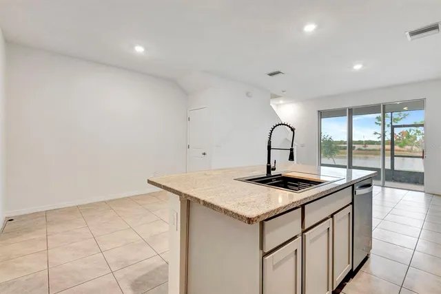 a kitchen with stainless steel appliances granite countertop a refrigerator and a stove