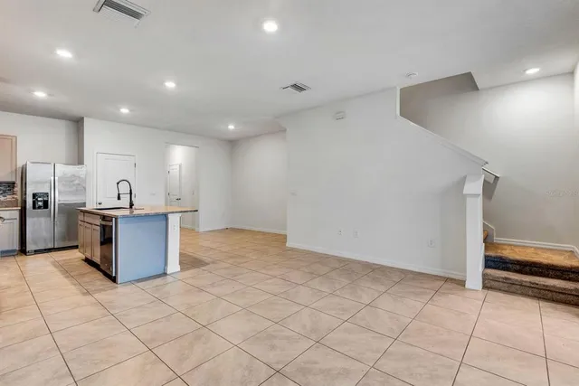 a kitchen with stainless steel appliances granite countertop a sink a stove a refrigerator a microwave and cabinets