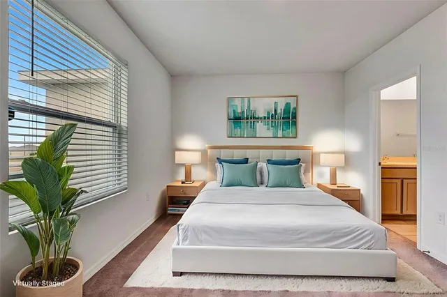a bathroom with a granite countertop sink a toilet and a large mirror