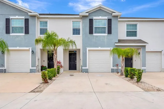 front view of a house with potted plants