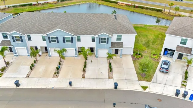 an aerial view of residential houses with outdoor space