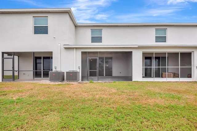 a view of a swimming pool with lawn chairs under an umbrella
