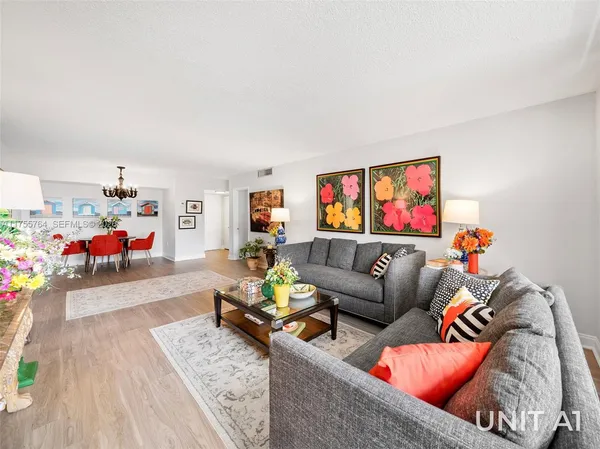 a kitchen with stainless steel appliances granite countertop a refrigerator a sink a stove a microwave and island