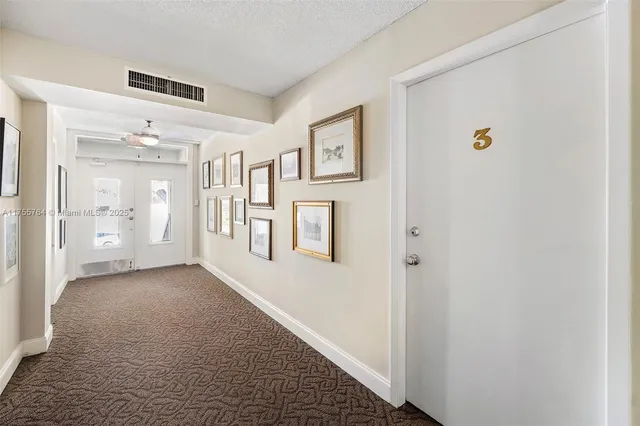 a living room with furniture kitchen view and a window