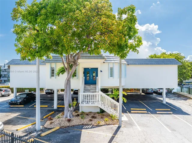 a view of a patio with table and chairs and potted plants
