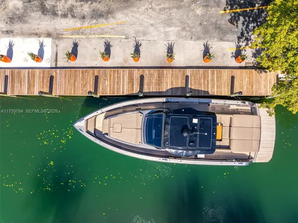 an aerial view of a house with outdoor space and lake view