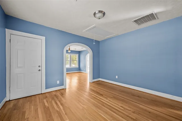 a view of empty room with wooden floor